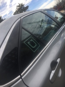 An Uber logo from a car, among many, used by students on American University's campus.